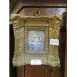 An ornate gilt framed watercolour of glum lady