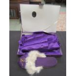 A boxed set of purple oriental style clothes to include shirt, trousers,