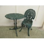 A green painted cast aluminium garden table and chair