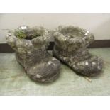 A pair of composite stone garden pots in the form of boots