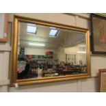 A modern gilt framed bevel glass rectangular wall mirror