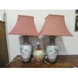 A pair of oriental style ceramic table lamps along with one other