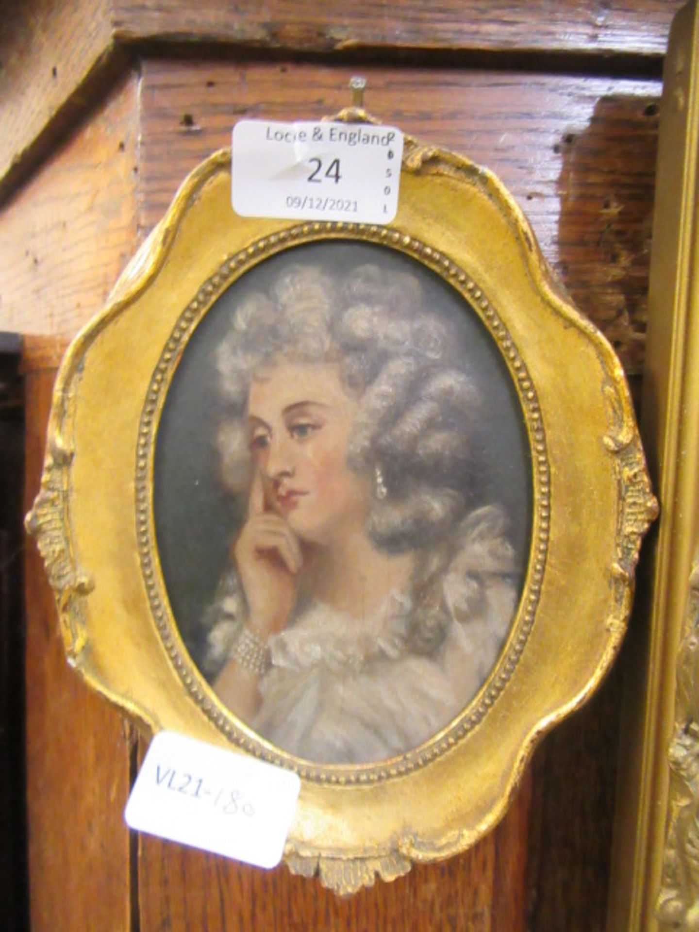 A gilt framed oil on card of pensive lady wearing pearls