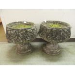 A pair of composite stone garden pots