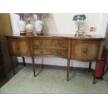 A reproduction mahogany and brass inlaid regency style sideboard