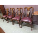 A set of four early 20th century walnut open arm chairs on cabriole legs
