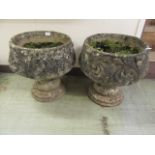 A pair of composite stone garden pots