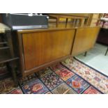 A mid-20th century teak sideboard having a pair of sliding doors