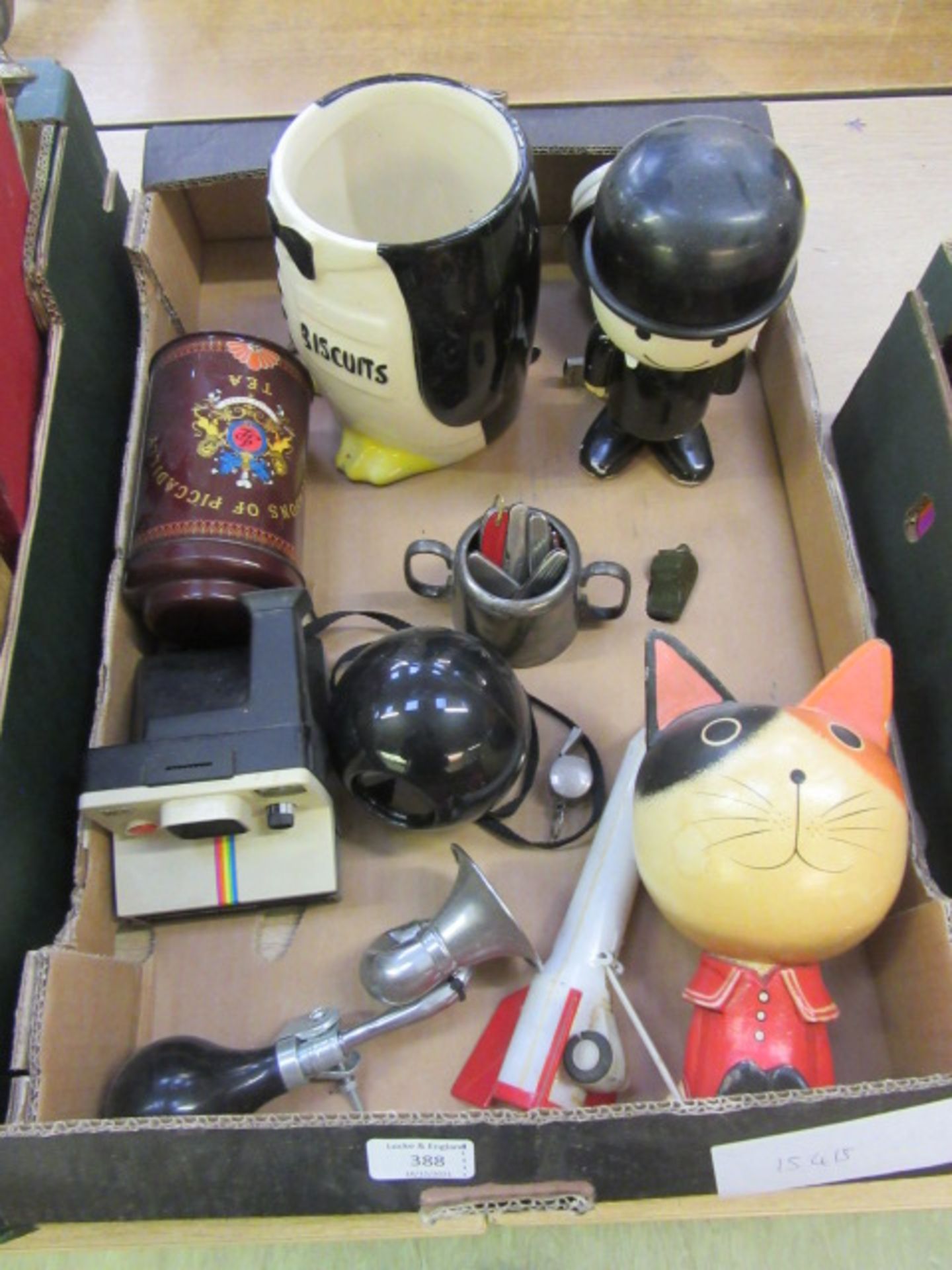 A tray containing an assortment of collectors items to include whistles.