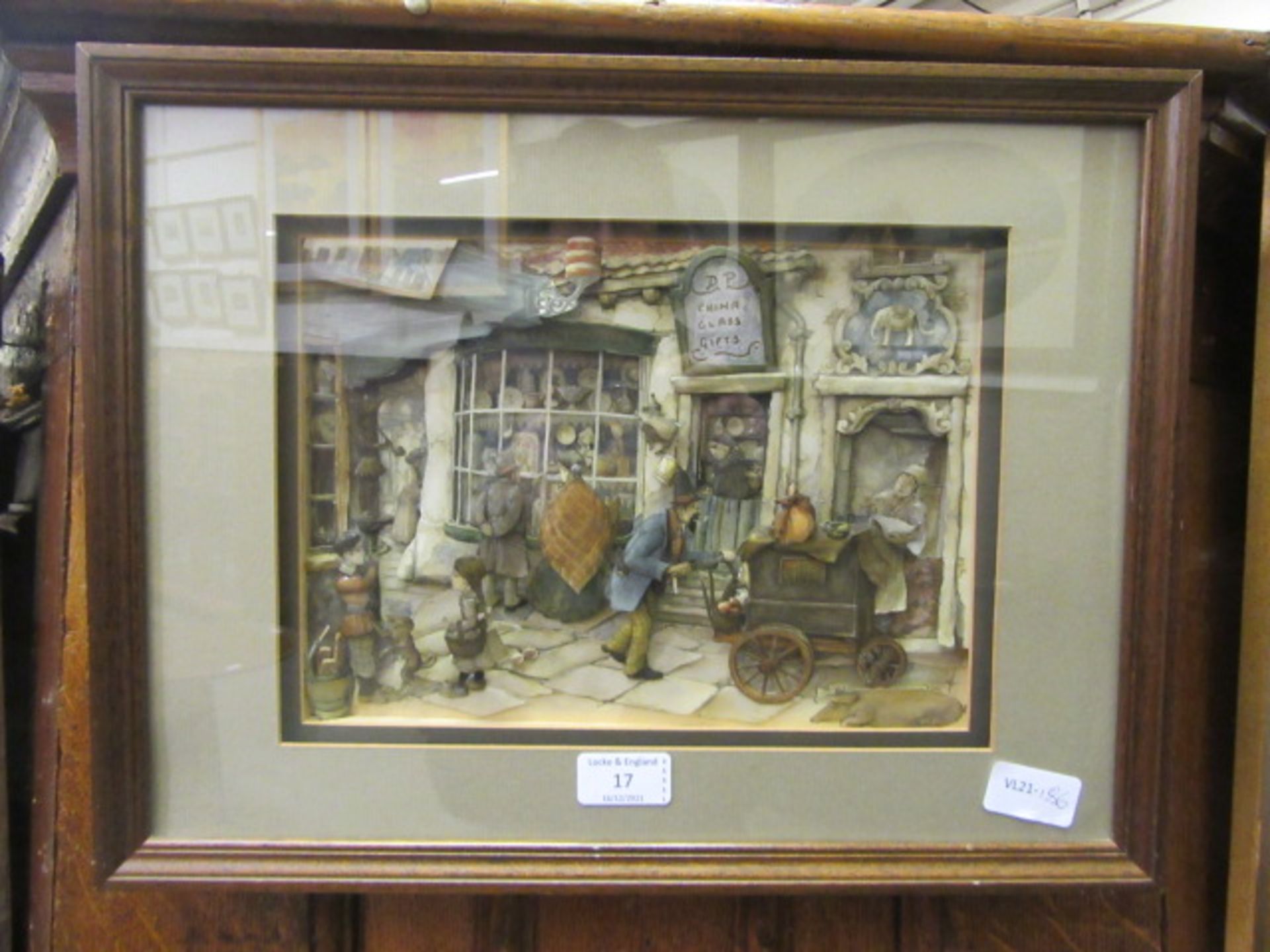 A framed and glazed diorama of shop scene