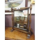 An oak framed swing toilet mirror