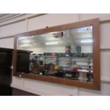 A modern oak framed beveled glass mirror