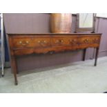 A mid 18th century oak and mahogany banded dresser base,