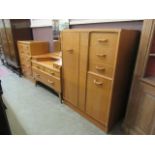 A mid 20th century oak chest of five long drawers,