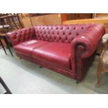 An ox blood leather button backed Chesterfield settee by Thomas Lloyd CONDITION REPORT: