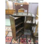 An oak jardiniere stand together with a small oak bookcase,