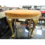 A modern oval stool with gilt cabriole legs