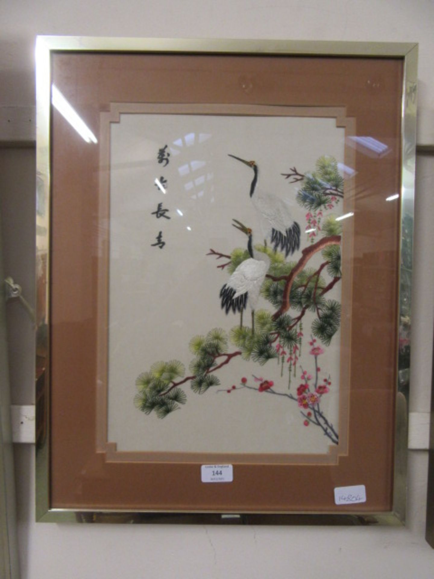A framed and glazed Japanese silk embroidery of birds in tree
