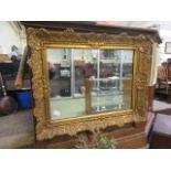 An ornate gilt framed rectangular mirror CONDITION REPORT: Size 79cm by 63cm Some