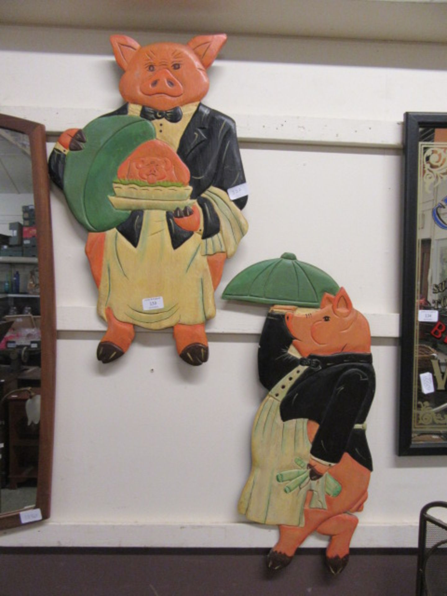 Two comical pig wall plaques