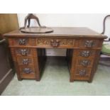 A Victorian carved oak pedestal desk,