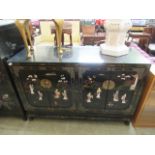 An Oriental style lacquered and hard stone relief panel sideboard,