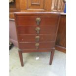 An early 20th century mahogany four drawer music cabinet