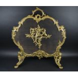 FIRE GUARD, circa 1900, French gilt metal and wire mesh with cast cherub decoration, 76cm H x 66cm W