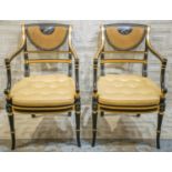 ARMCHAIRS, a pair, Regency style ebonised, gilt, painted and caned with gold squab cushions, 55cm W.