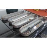 TRAYS, a set of four, mirrored bases, with handles, 61cm x 15,5cm x 5,5cm. (4)