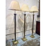 CORINTHIAN COLUMN FLOOR LAMPS, a set of three, brass with pleated shades, 167cm H. (3) (with faults)