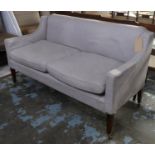 SOFA, of compact proportions in a loose linen style cover on square tapering supports castors,