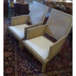 ARMCHAIRS, a pair, each with a caned front, back, both sides and a cream seat, 70cm W x 89cm H. (