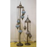 STANDING LAMPS, Moroccan patinated brass, with five ceramic and glass adorned shades, 165cm H, and a