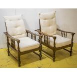 RECLINING ARMCHAIRS, a pair, beechwood, with adjustable backs and cream cushions (slight marks),