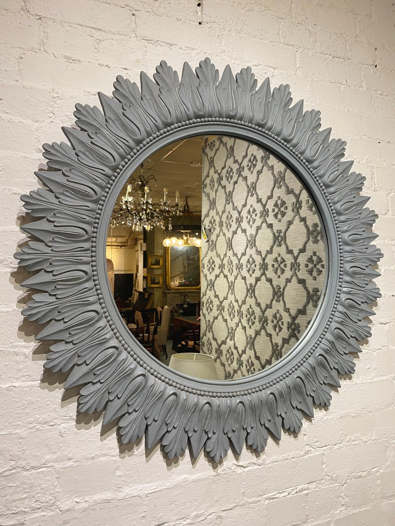 STARBURST WALL MIRROR, 1960's design, carved and painted wood, 92cm diam.