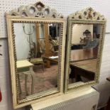 WALL MIRRORS, two painted, each with a wavy, scrolled surmount, 50cm W x 87cm H. (2) (with faults)