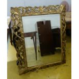 WALL MIRROR, 19th century Continental giltwood and gesso with a pierced frame and bevelled plate,