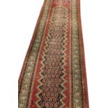ANTIQUE PERSIAN SARABAND RUNNER, 305cm x 81cm, all over boteh field.