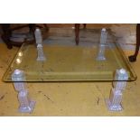 LOW TABLE, the bevelled glass top on mother of pearl veneered supports, 104cm W x 104cm D. (with