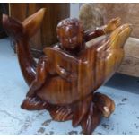 SCULPTURE, carved hardwood in the form of a child and dolphin, 62cm H x 72cm L x 27cm W.