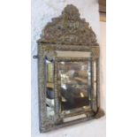 WALL MIRROR, 19th century Flemish repoussé brass with a cushioned frame, 33cm W x 61cm H. (with