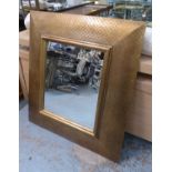 WALL MIRROR, with a gilt frame in a fish scale pattern, 92cm x 105cm.