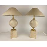 ATTRIBUTED TO PHILIPPE BARBIER TABLE LAMPS, a pair, 1970's French travertine and brass, with shades,