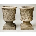 PLANTERS, a pair, reconstituted sandstone of cone form with basket weave exterior and socle plinth