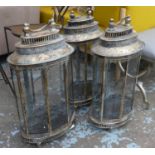 STORM LANTERNS, a set of three, aged gilt finish, 70cm H approx. (3)