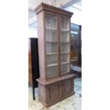 TALL BOOKCASE, Gothic revival painted with a dentil cornice over a pair of glazed doors enclosing