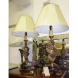 LAMPS, a pair, with curved, carved gilt detail of triform bases in a faux rosewood, painted
