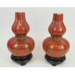 JAPANESE GOURD VASES, a pair, triple neck in coral red glaze with gilt decorated bow on shaped