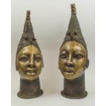 BENIN HEADS, a pair, cast bronze with pinicle hats, 50cm H.